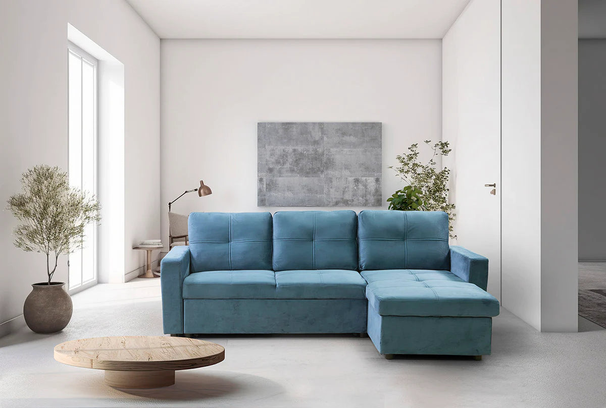 Sofá cama Pau azul con chaise longue en un salón luminoso