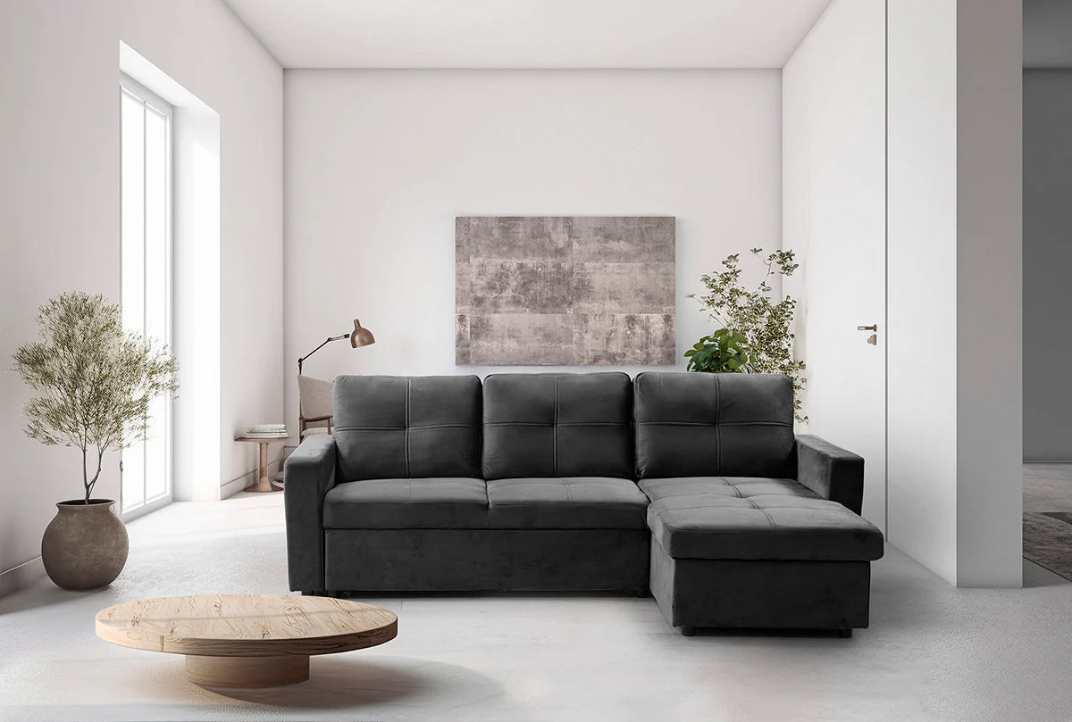 Sofá cama Pau negro con chaise longue en un salón luminoso