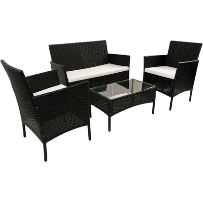 Vista del sofá, dos sillones acolchados y mesa del conjunto de exterior