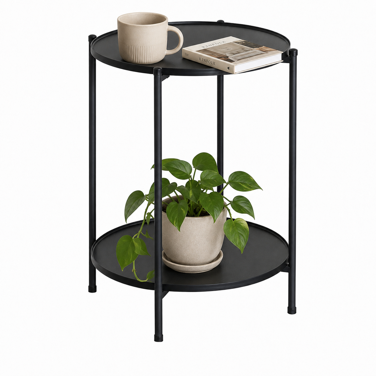 Mesa auxiliar redonda negra con taza, libro y planta